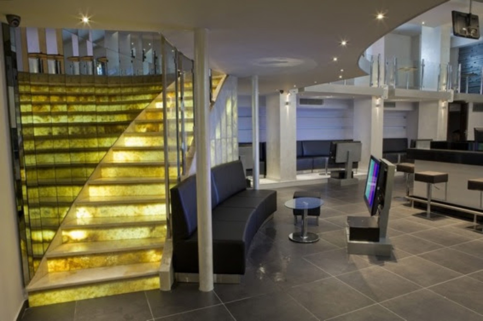 Contemporary lounge with illuminated staircase
