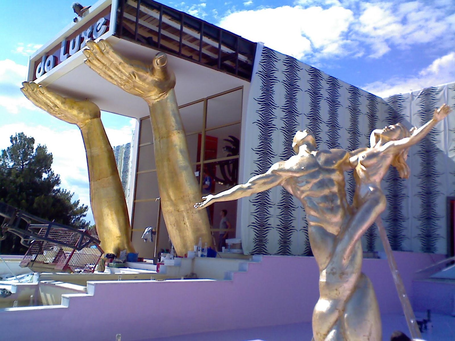 Giant gold hands and dancer sculptures