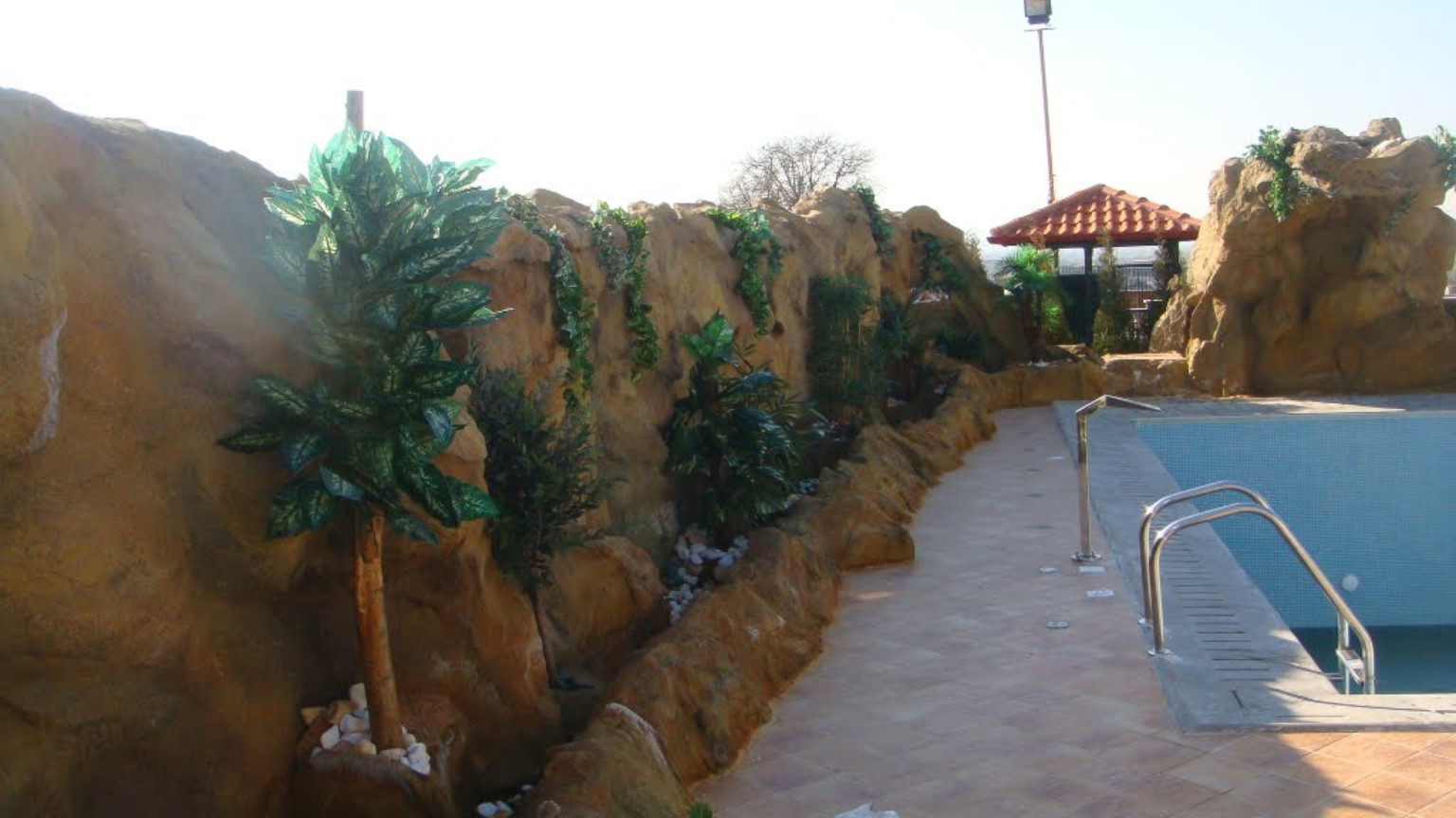 Artificial rockwork beside a swimming pool